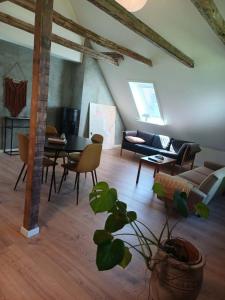 a living room with a couch and a table at Kroghuset - Det Lille Hotel in Tarm