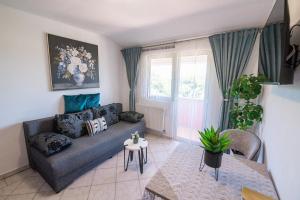 a living room with a couch and a table at Apartments Anita in Pula