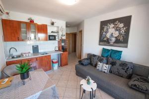 a living room with a couch and a kitchen at Apartments Anita in Pula