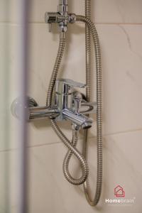 a shower head with a hose in a bathroom at MOS luxury project by Homebrain in Alexandroupoli +59 photos