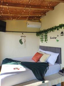 a bed in a room with plants on the wall at Recanto Vista Verde in Nova Petrópolis