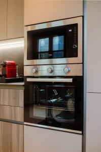 a microwave sitting on top of an oven in a kitchen at Casa Vacanze Centrale in Mori