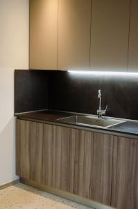 a kitchen with a sink and a counter top at Casa Vacanze Centrale in Mori +24 photos