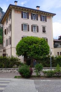 a large building with a tree in front of it at Casa Vacanze Centrale in Mori