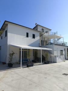 a large white building with awning in front of it at Villa Ranucci Formia guesthouse in Formia
