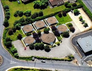 an overhead view of a park with trees and a road at Mâcon Nord Hôtel, Ex Charme En Maconnais in Mâcon