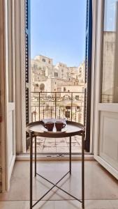 a table in a room with a view of a city at Giù nei Sassi in Matera