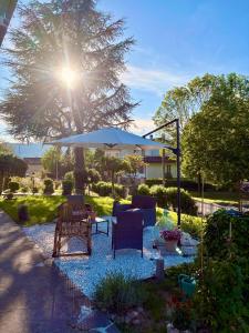 a patio with two chairs and an umbrella at Ca' di Romagna B&B in Civitella di Romagna