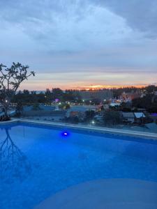 a large swimming pool with a view of a city at Fantasea Condo Kamala 1bdr in Kamala Beach