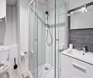 a bathroom with a shower and a toilet and a sink at Le Charmant - plage & restaurants à pied, Houlgate in Houlgate