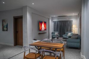 a living room with chairs and a table and a couch at Burj Al Salam Hotel in Al ‘Alwīyah