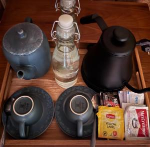 a drawer with a tea kettle and a bottle of water at Joglo Ulu Home in Uluwatu