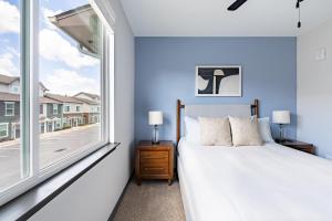 a bedroom with a bed and a large window at Landing Modern 3BD Gym Rooftop Lounge in Bellview +91 photos