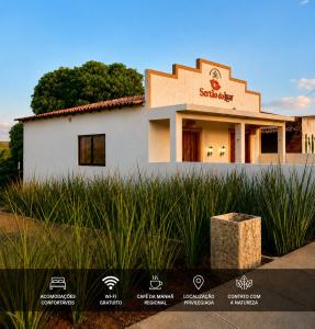 a building with a sign on the side of it at Chalé Caroá in São Raimundo Nonato +4 photos