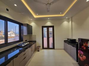 a kitchen with a counter and a large window at Kamal in Kārli