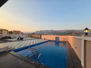 a swimming pool on the roof of a building at Kamal in Kārli