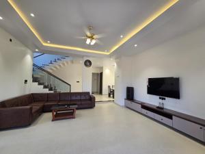a living room with a couch and a flat screen tv at Kamal in Kārli