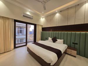 a bedroom with a large bed and a large window at Kamal in Kārli +27 photos
