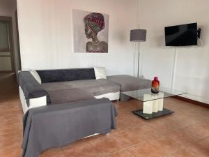 a living room with a couch and a table at Pépite Anses in Les Anses-dʼArlets