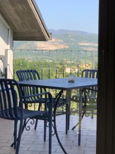 a blue table and chairs on a balcony with a view at B&B Da Mariella in Spigno Saturnia