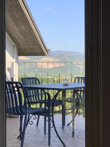 a table and chairs on a patio with a view of a field at B&B Da Mariella in Spigno Saturnia +20 photos