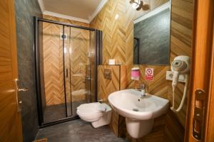 a bathroom with a shower and a toilet and a sink at Palmada Hotel in Sakarya +184 photos