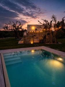 a large swimming pool in front of a house at Emerald Suites - Villa Emerald in San Vito dei Normanni