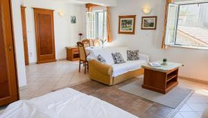 a living room with a bed and a table at Apartments Residence Astoria in Rab