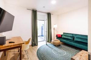 a living room with a green couch and a table at Apartment in Bayreuth in Bayreuth