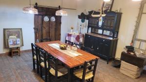 a dining room with a wooden table and a wooden cabinet at Namasté in Villa Larca