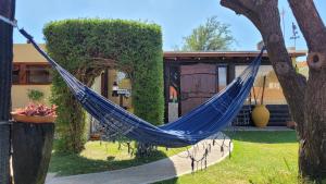a blue hammock in front of a house at Namasté in Villa Larca