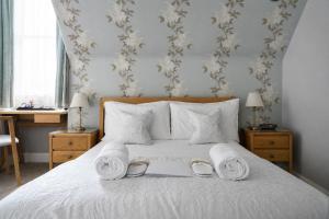 a bedroom with a bed with towels on it at Gladstone House in Edinburgh +38 photos