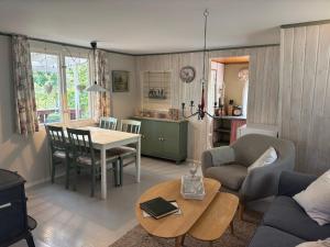 a living room with a couch and a table at Hus Sinnermåla in Högsby