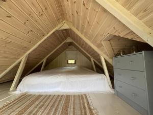 a bedroom with a bed in a attic at Hus Sinnermåla in Högsby