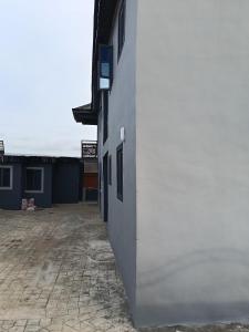 a white wall of a building with a courtyard at Bec property in Ikorodu