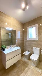 a bathroom with a toilet and a sink at La Casa de la Vall in Castellbell i Vilar