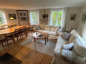 a living room with couches and a table and a dining room at Hus Blommekulla in Högsby