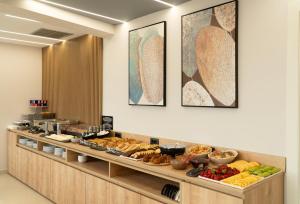 a buffet line with many different types of food at Erdeti Boutique Hotel in Sarandë