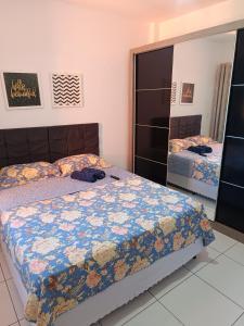 a bedroom with a bed with a quilt on it at Ap Completo na zona Nobre com 3 quartos, sendo 1 suíte in Teresina