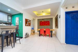 a kitchen with a blue door and a table with red chairs at Roemah Noni Baciro By ARBA in Demangan +26 photos