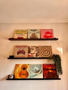 two shelves filled with books on a wall at Casa Midu Beachhouse 450m to the Beach in Los Alcázares
