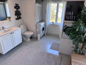 a bathroom with a toilet sink and a washing machine at Hus Hagagatan in Ruda +37 photos