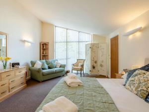 a bedroom with a large bed and a couch at 2 Bed in Wells oc-46310 in Wells