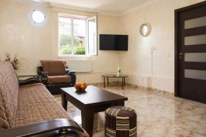 a living room with a couch and a table at apartament dato in Batumi
