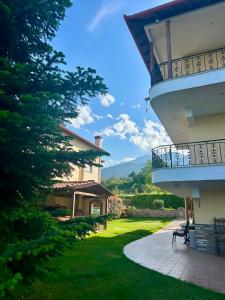 a view of a house with a balcony and a yard at Apartment Achilles in Litochoro