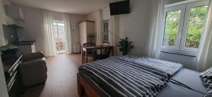 a bedroom with a bed and a table in it at Apartments Leipziger Neuseenland in Markkleeberg