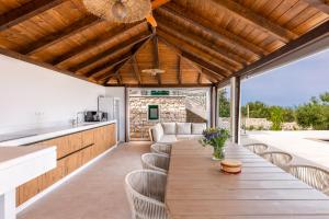 a kitchen and dining room with a long table and chairs at Villa Andrea in Splitska