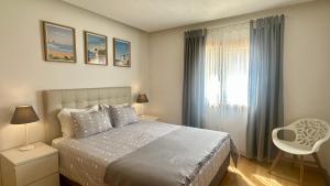 a bedroom with a bed and a window at Garden Hill M - Shared Pool - 6 Guests - Albufeira in Albufeira