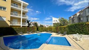 a swimming pool in front of a building at Garden Hill M - Shared Pool - 6 Guests - Albufeira in Albufeira +27 photos