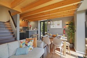 a kitchen and living room with a couch and a table at Piu Bella in Fajã da Ovelha +23 photos